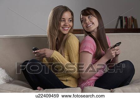 Portrait of teenage girl (16-17) with young woman sitting on sofa View Large Photo Image Stock Photo - Portrait of teenage girl (16-17) with young woman sitting on sofa. Fotosearch