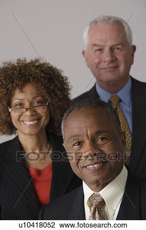Portrait of three business people, studio shot View Large Photo Image Stock Image - Portrait of three business people, studio shot. Fotosearch