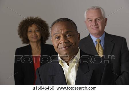 Portrait of three business people, studio shot View Large Photo Image Stock Image - Portrait of three business people, studio shot. Fotosearch