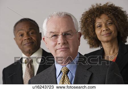 Portrait of three business people, studio shot View Large Photo Image Stock Image - Portrait of three business people, studio shot. Fotosearch