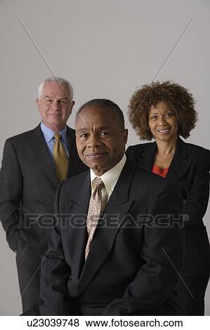 Portrait of three business people, studio shot View Large Photo Image Stock Photo - Portrait of three business people, studio shot. Fotosearch