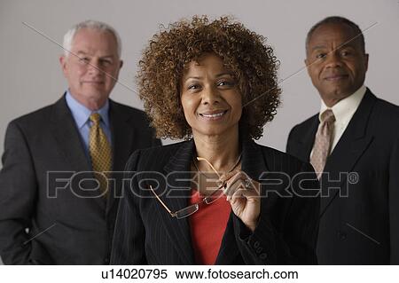 Stock Photography - Portrait of three business people, studio shot. Fotosearch