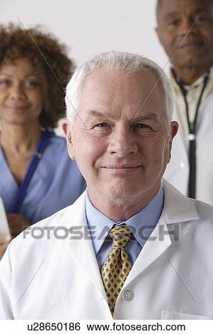 Stock Photograph - Portrait of three medical professionals, studio shot. Fotosearch