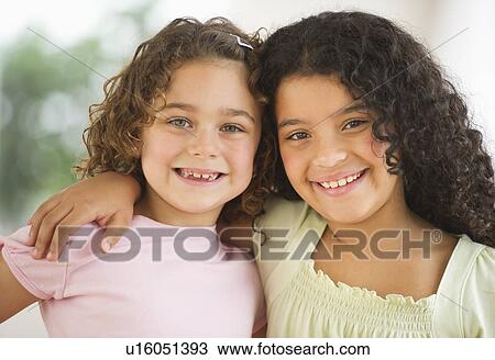 Stock Image - Portrait of two girls (6-9). Fotosearch