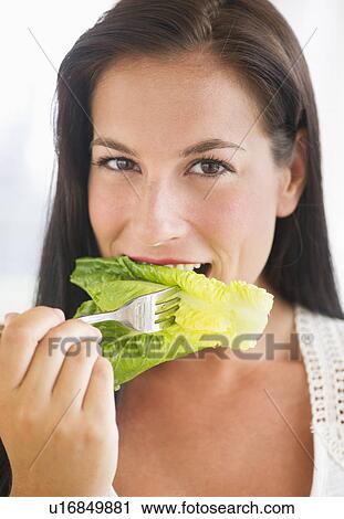 Portrait of woman eating lettuce View Large Photo Image Stock Image - Portrait of woman eating lettuce. Fotosearch