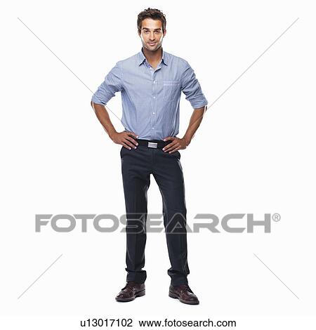 Portrait of young business man standing with hands on hips and smiling against white background View Large Photo Image Stock Image - Portrait of young business man standing with hands on hips and smiling against white background. Fotosearch