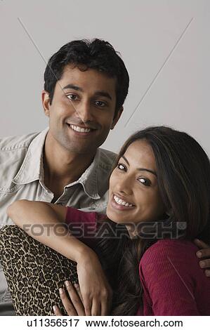 Stock Photo - Portrait of young couple, studio shot. Fotosearch