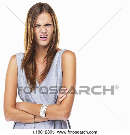 Portrait of young distressed woman standing with hands folded View Large Photo Image Stock Photography - Portrait of young distressed woman standing with hands folded. Fotosearch