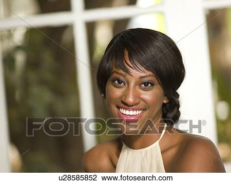Stock Image - Portrait of young smiling woman. Fotosearch