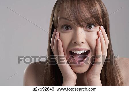 Portrait of young surprised woman, studio shot View Large Photo Image Stock Image - Portrait of young surprised woman, studio shot. Fotosearch