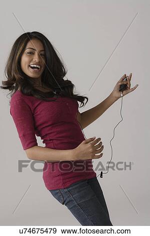 Portrait of young woman, studio shot View Large Photo Image Stock Photo - Portrait of young woman, studio shot. Fotosearch