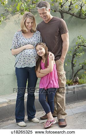 Pregnant mother, father and daughter (6-7) posing for portrait View Large Photo Image Stock Photography - Pregnant mother, father and daughter (6-7) posing for portrait. Fotosearch