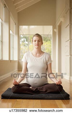 Pregnant woman practicing yoga View Large Photo Image Stock Image - Pregnant woman practicing yoga. Fotosearch