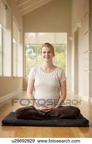 Pregnant woman practicing yoga View Large Photo Image Stock Photo - Pregnant woman practicing yoga. Fotosearch