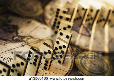 Row of dominoes on old world map View Large Photo Image Stock Photography - Row of dominoes on old world map. Fotosearch