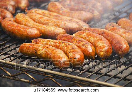 Stock Photo - Sausages on barbeque. Fotosearch