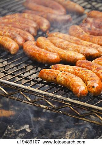 Stock Photo - Sausages on barbeque. Fotosearch