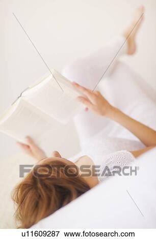 Sensual portrait of young woman reading book View Large Photo Image Stock Photo - Sensual portrait of young woman reading book. Fotosearch