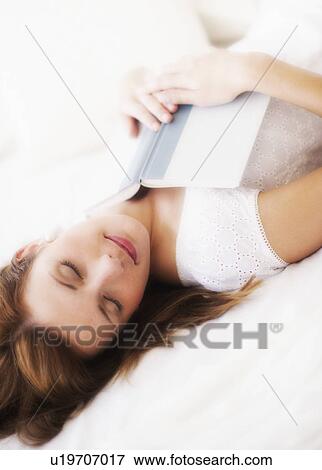 Sensual portrait of young woman with book View Large Photo Image Stock Photo - Sensual portrait of young woman with book. Fotosearch