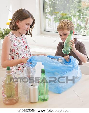 sister (6-7) and brother (4-5) sorting rubbish at home View Large Photo Image Picture - sister (6-7) and brother (4-5) sorting rubbish at home. Fotosearch