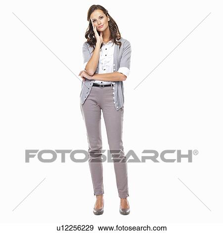 Smiling female executive with hand on chin against white background View Large Photo Image Stock Photo - Smiling female executive with hand on chin against white background. Fotosearch
