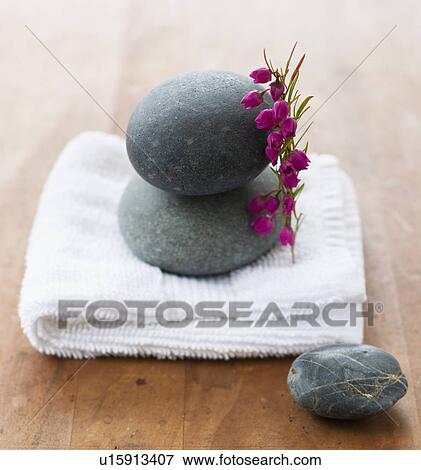 Stock Photo - Stones on towel at spa. Fotosearch