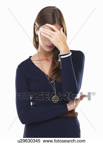 Stressed woman with hand on forehead standing View Large Photo Image Stock Photography - Stressed woman with hand on forehead standing. Fotosearch