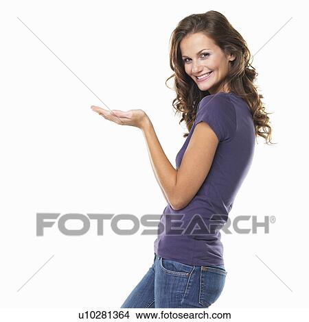Studio portrait of attractive young woman gesturing and smiling View Large Photo Image Picture - Studio portrait of attractive young woman gesturing and smiling. Fotosearch