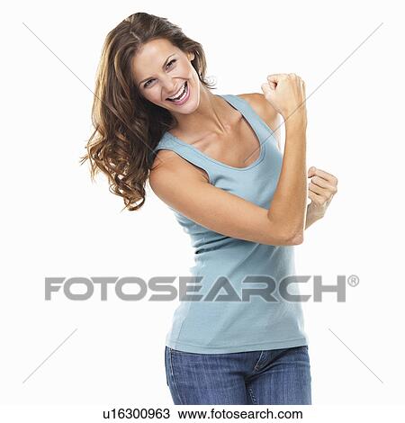 Studio portrait of attractive young woman with fists clenched View Large Photo Image Stock Image - Studio portrait of attractive young woman with fists clenched. Fotosearch