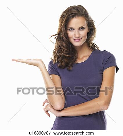 Studio portrait of attractive young woman gesturing and smiling View Large Photo Image Stock Photo - Studio portrait of attractive young woman gesturing and smiling. Fotosearch