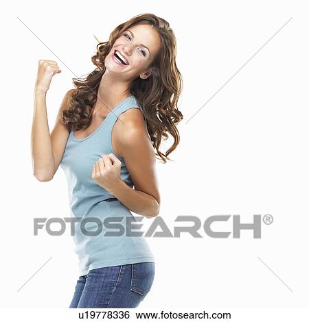 Stock Photograph - Studio portrait of attractive young woman celebrating success. Fotosearch