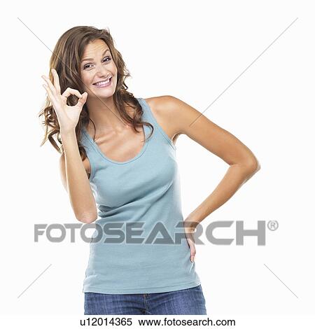 Studio portrait of attractive young woman showing ok sign View Large Photo Image Stock Photography - Studio portrait of attractive young woman showing ok sign. Fotosearch