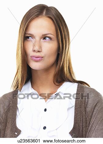 Studio portrait of beautiful business woman looking away with lips pursed View Large Photo Image Stock Image - Studio portrait of beautiful business woman looking away with lips pursed. Fotosearch