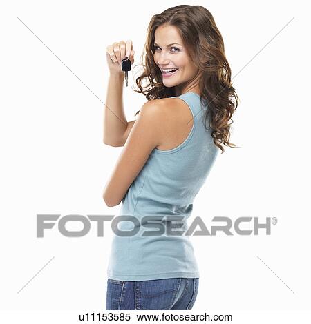 Studio portrait of beautiful woman turning around and holding car keys View Large Photo Image Stock Photography - Studio portrait of beautiful woman turning around and holding car keys. Fotosearch