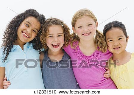 Stock Image - Studio portrait of embracing girls (6-7, 8-9). Fotosearch