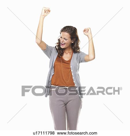 Stock Photo - Studio portrait of excited young woman cheering. Fotosearch