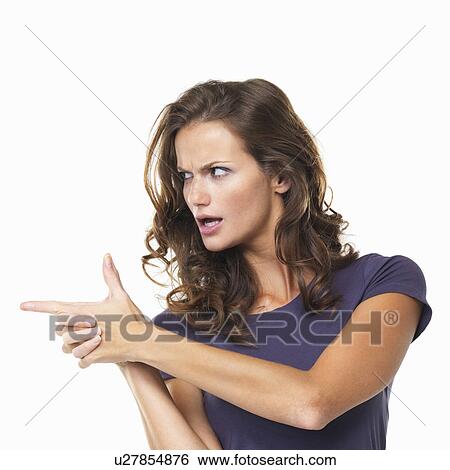 Stock Photograph - Studio portrait of making gun shape with both hands and pointing away. Fotosearch