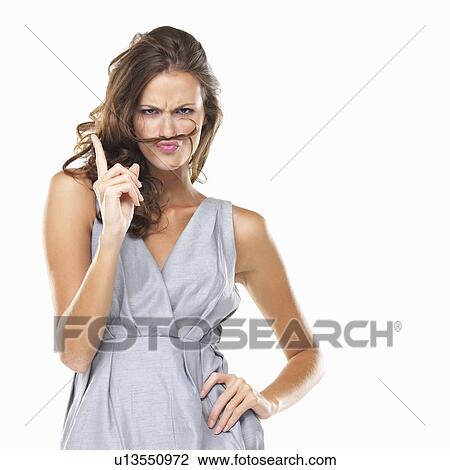 Studio portrait of playful woman with moustache made of hair View Large Photo Image Stock Image - Studio portrait of playful woman with moustache made of hair . Fotosearch