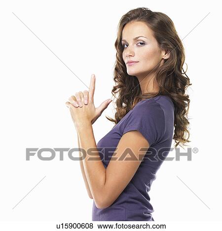 Studio portrait of pretty woman making shape of gun with hands View Large Photo Image Stock Photo - Studio portrait of pretty woman making shape of gun with hands. Fotosearch
