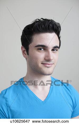 Studio portrait of smiling young man View Large Photo Image Stock Photo - Studio portrait of smiling young man. Fotosearch
