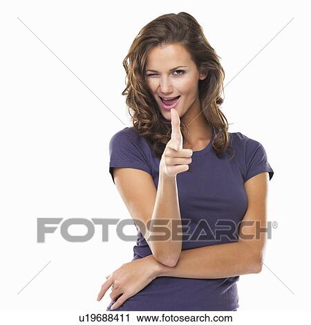 Studio portrait of woman pointing at camera and winking View Large Photo Image Stock Image - Studio portrait of woman pointing at camera and winking. Fotosearch