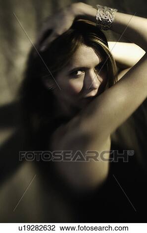 Studio portrait of woman with long hair View Large Photo Image Stock Image - Studio portrait of woman with long hair. Fotosearch