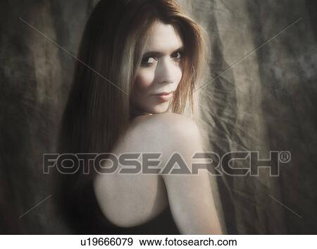 Studio portrait of woman with long hair View Large Photo Image Stock Photo - Studio portrait of woman with long hair. Fotosearch