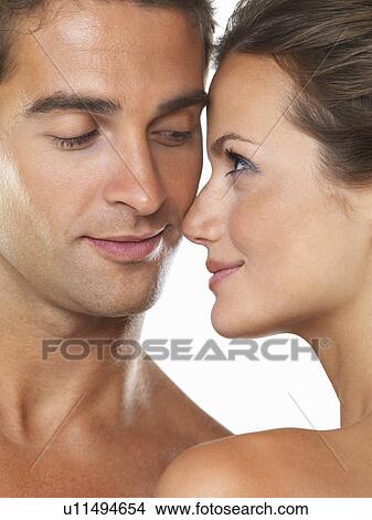 Studio portrait of young attractive couple looking at each other View Large Photo Image Picture - Studio portrait of young attractive couple looking at each other. Fotosearch