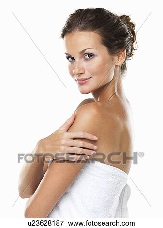 Stock Photo - Studio portrait of young attractive woman wrapped in towel. Fotosearch