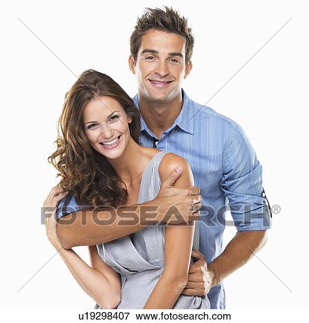 Stock Photo - Studio portrait of young couple smiling. Fotosearch