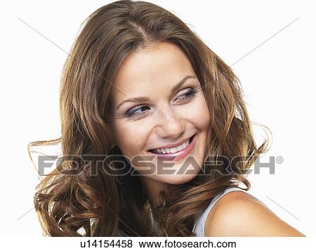 Studio portrait of young woman smiling and looking away View Large Photo Image Stock Photo - Studio portrait of young woman smiling and looking away. Fotosearch