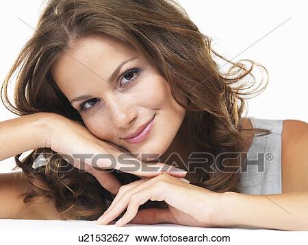 Studio portrait of young woman smiling View Large Photo Image Stock Photo - Studio portrait of young woman smiling. Fotosearch