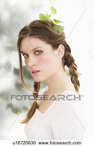 Studio portrait of young woman with leaves in hair View Large Photo Image Stock Image - Studio portrait of young woman with leaves in hair. Fotosearch