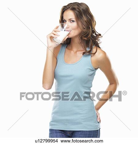 Picture - Studio shot of attractive young woman drinking milk. Fotosearch